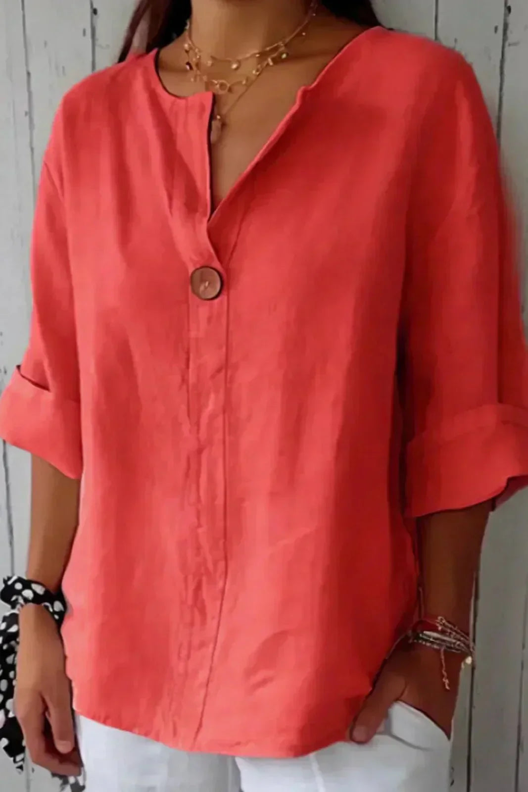 Relaxed red button-up top with V-neck and short sleeves, front button placket.