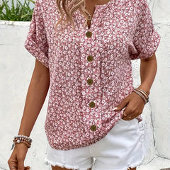 Pink floral print blouse with V-neckline, gold button placket, and short sleeves