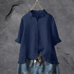 Navy blue button-up blouse top with collar, short sleeves, and ruffled hem detail