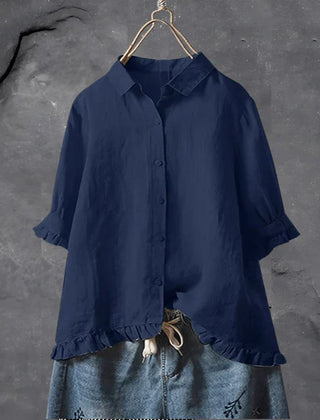 Navy blue button-up blouse top with collar, short sleeves, and ruffled hem detail
