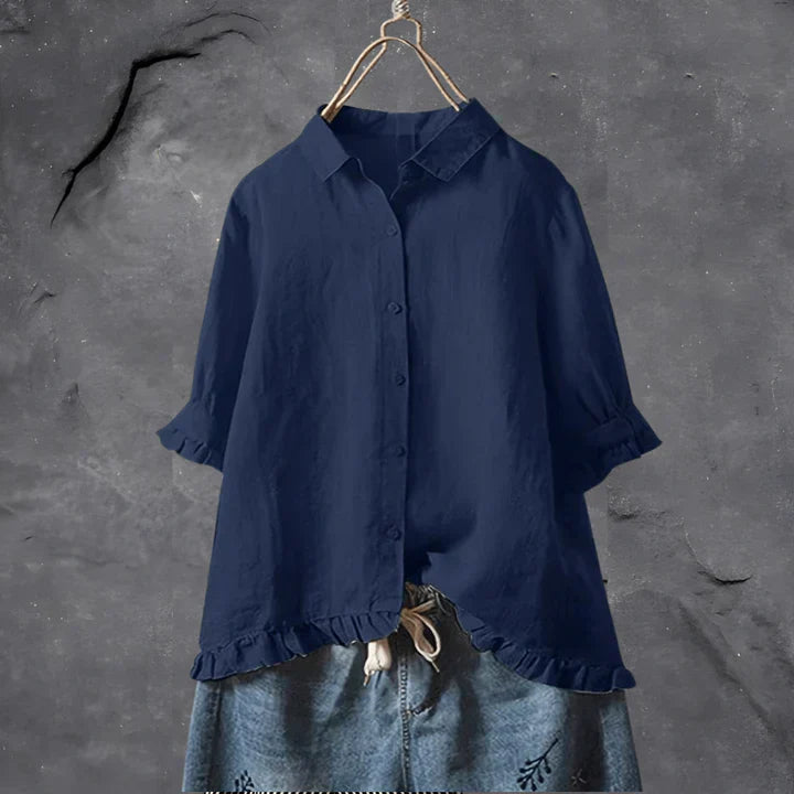 Navy blue button-up blouse top with collar, short sleeves, and ruffled hem detail