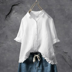 White button-up blouse top with collar, short sleeves, and ruffled hem detail