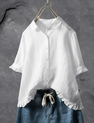 White button-up blouse top with collar, short sleeves, and ruffled hem detail