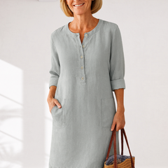 Light gray linen-look everyday dress with front buttons and side pockets, three-quarter sleeves