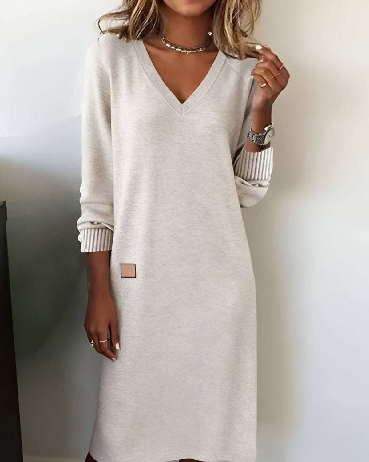 White V-neck midi dress with ribbed striped cuffs and small square side patch
