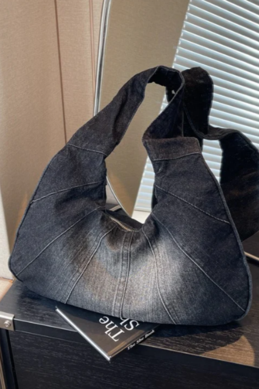 Denim shoulder bag in charcoal with wide top handles and slouchy crescent shape