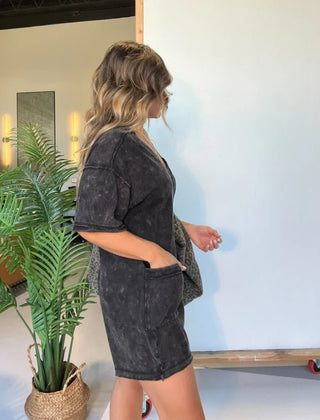 Washed black short-sleeve V-neck romper with patch pockets and relaxed fit