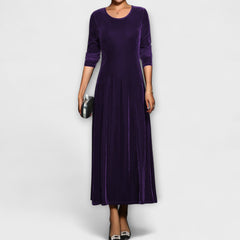 Purple soft velvet dress with long sleeves, round neck, fitted bodice and midi skirt