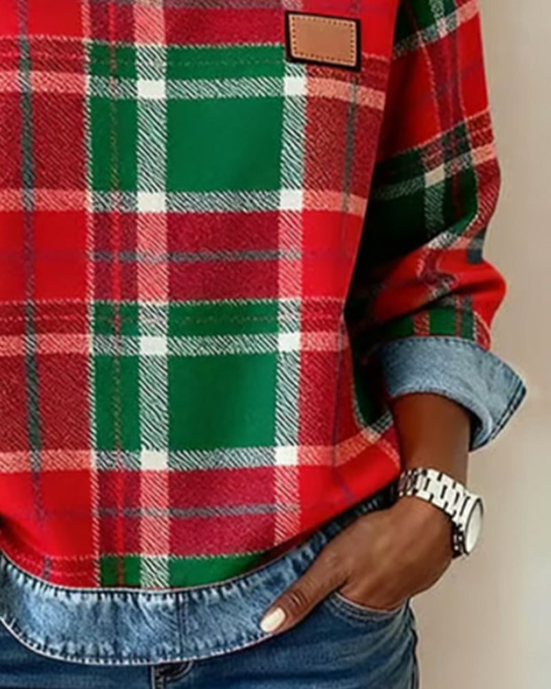 Plaid top close-up with denim cuff trim, red-and-green grid pattern