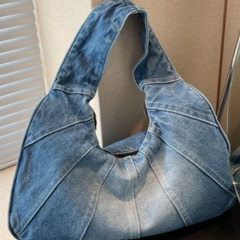 Denim shoulder bag in light blue with wide top handles and curved, open top