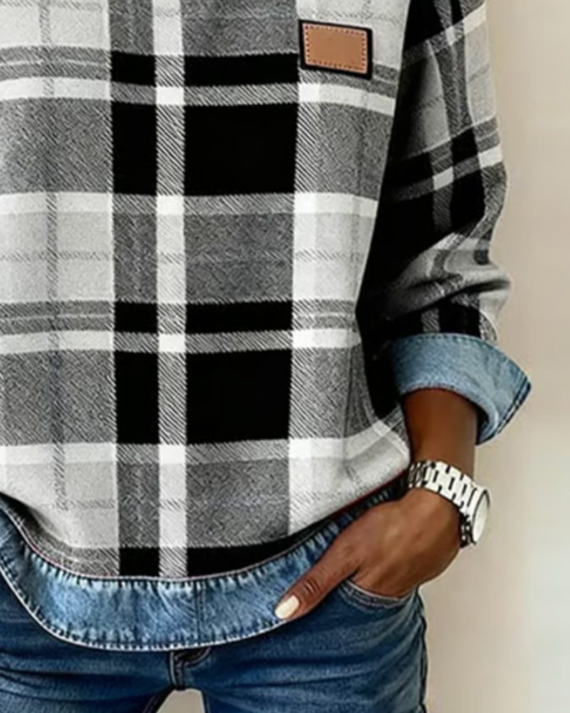 Plaid top close-up with denim cuff trim and black-and-white grid pattern