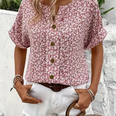 Pink floral print blouse with rounded V-neck, gold button placket, and relaxed fit