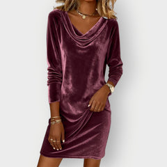 Purple velvet drape-neck dress with long sleeves and cowl neckline, above-knee length.
