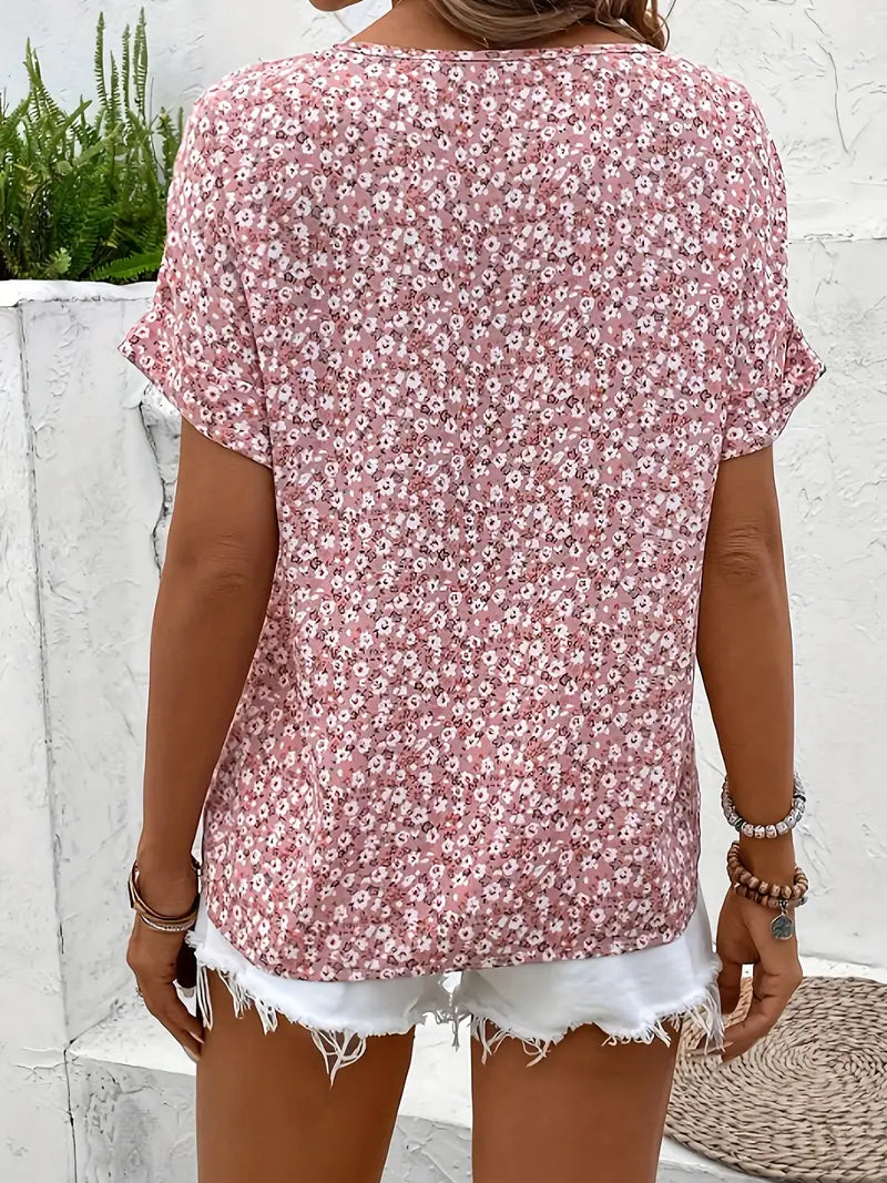Pink floral print blouse with short dolman sleeves and button-front detail (back view)