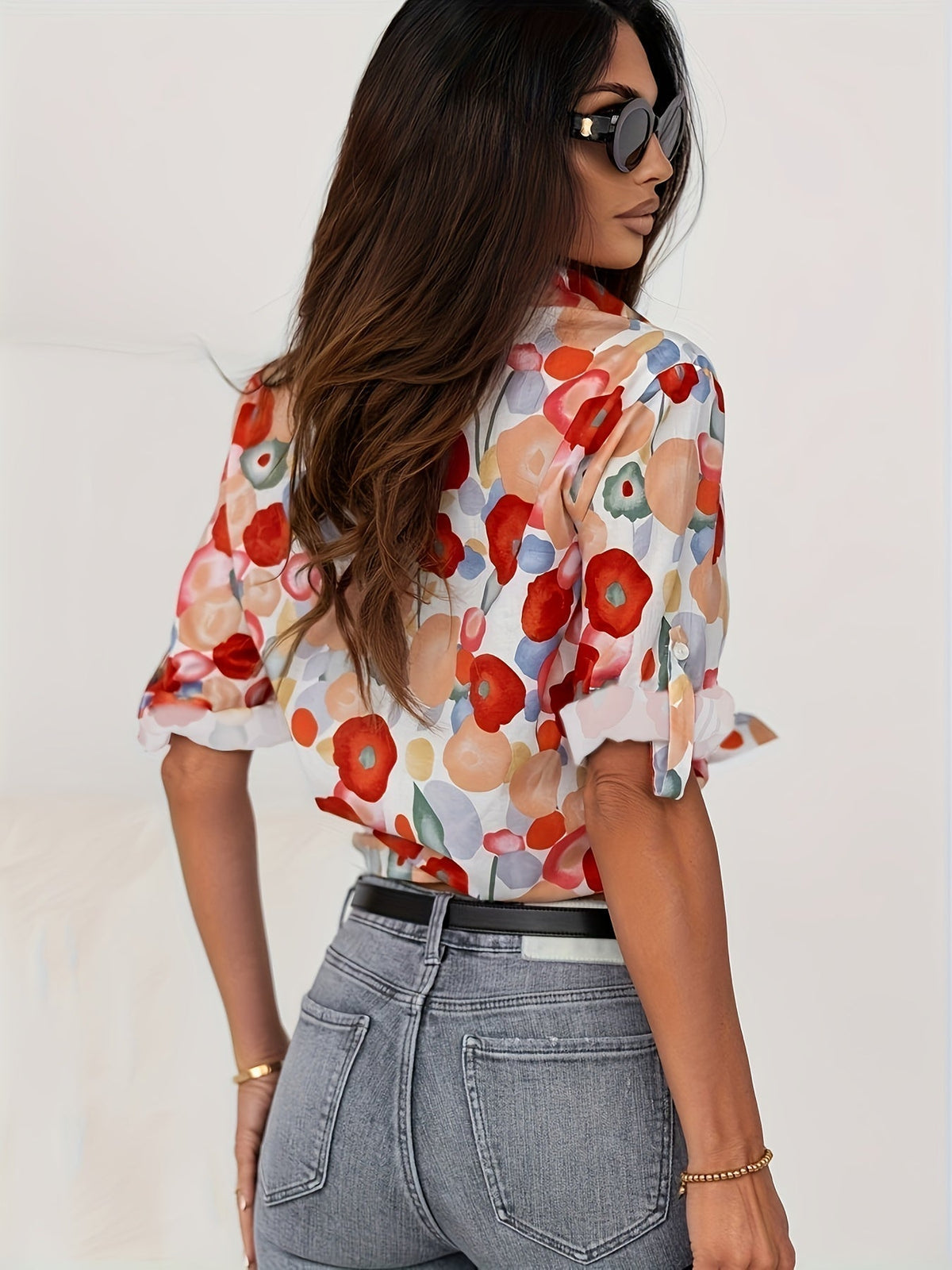 Colorful floral blouse in side view, button-front and long sleeves