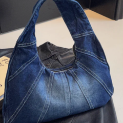 Denim shoulder bag in dark blue with wide top handles and panel stitching