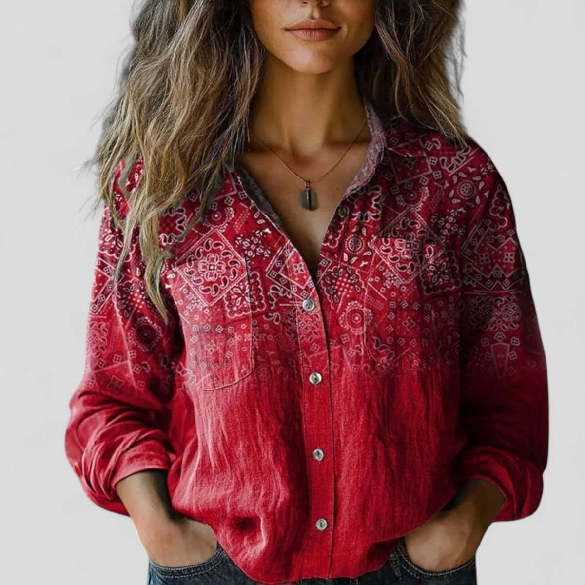 Red patterned button-up blouse shirt with chest pockets, rolled sleeves, and collar