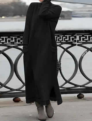 Black hooded winter maxi dress with long sleeves, front pockets, and side slit