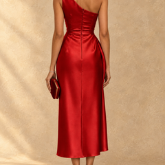 One-shoulder ruched satin midi dress back view in red, fitted waist and seam detailing