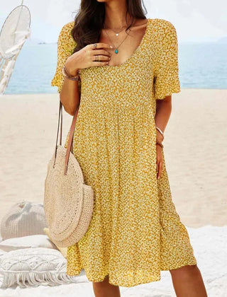 Yellow floral babydoll dress with V-neck and short sleeves, knee-length