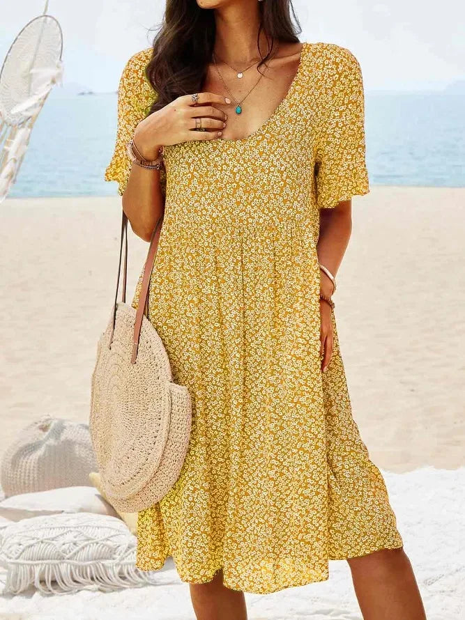 Yellow floral babydoll dress with V-neck and short sleeves, knee-length