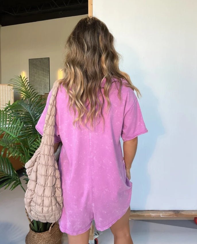 Washed pink short-sleeve V-neck romper with relaxed fit and patch pockets