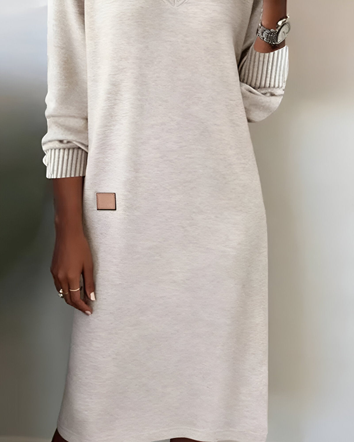 White V-neck knit midi dress detail view of square side patch and ribbed cuffs