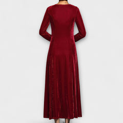 Red soft velvet dress back view with long sleeves and midi length flowy skirt