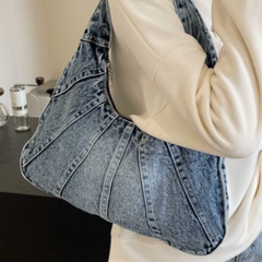 Blue denim shoulder bag with wide straps and stitched panel pattern