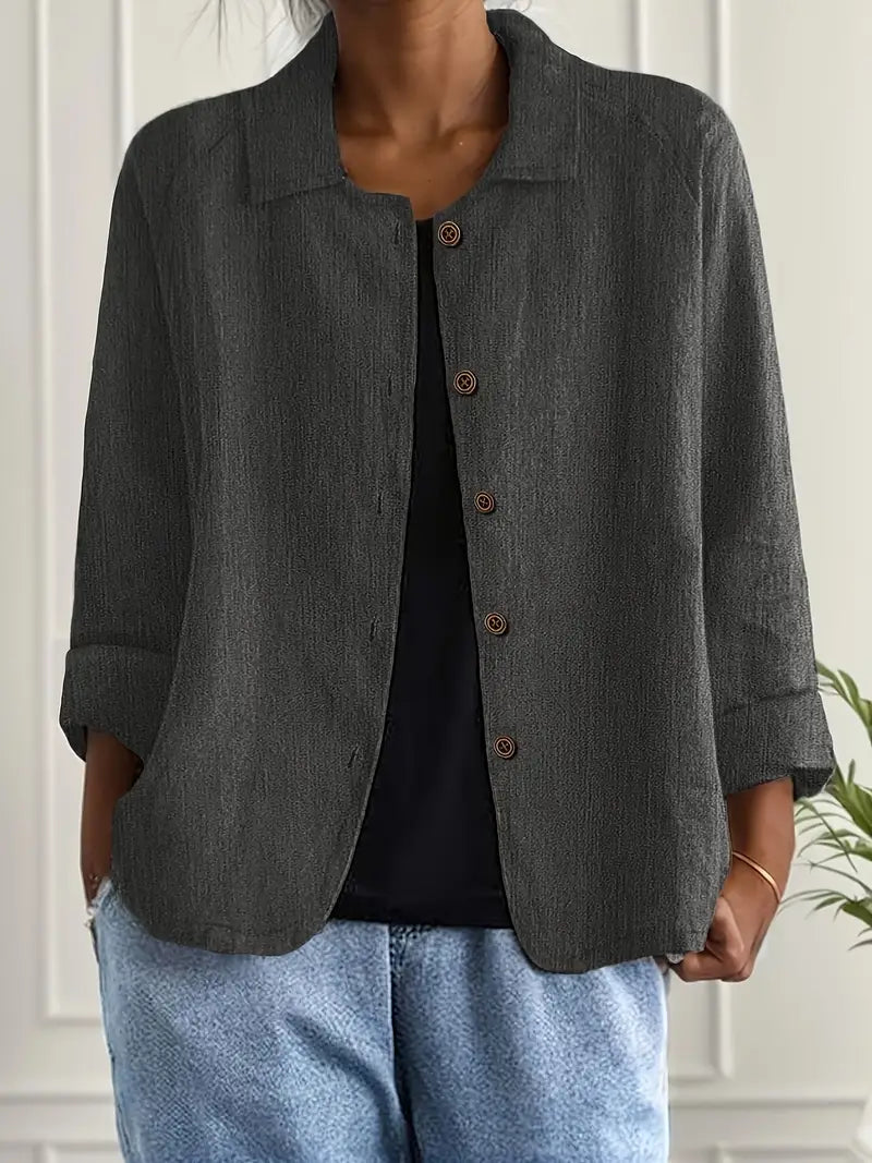 Charcoal gray button-front light top with pointed collar and three-quarter sleeves