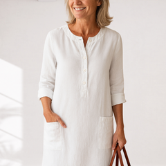 White linen-look everyday dress with front buttons and side pockets, three-quarter sleeves