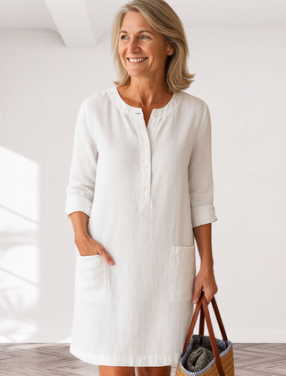 White linen-look everyday dress with front buttons and side pockets, three-quarter sleeves