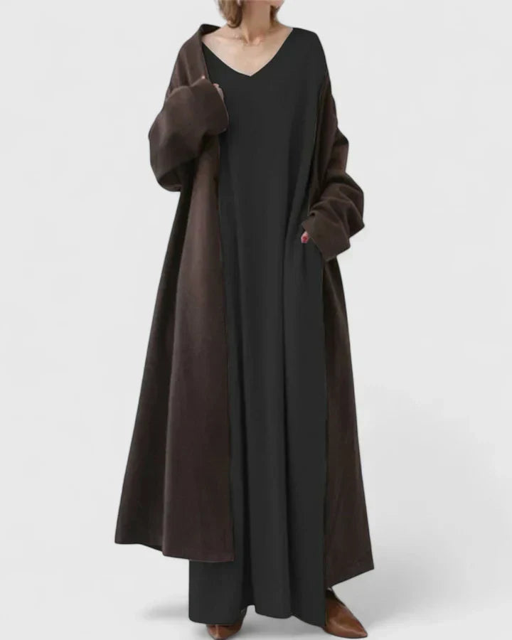 Black long-sleeve maxi dress with V-neck, relaxed drape, and side slit hem