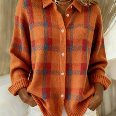 Orange plaid knit vest with V-neck, button front, long sleeves, ribbed cuffs.