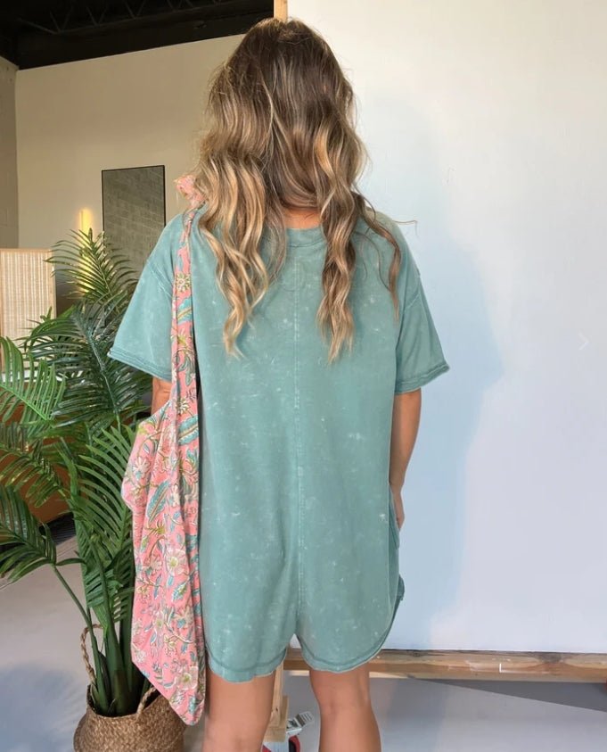 Washed gray-green short-sleeve V-neck romper with relaxed fit and patch pockets
