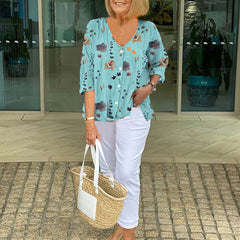 Printed button tunic top in sky blue with floral pattern, three-quarter sleeves
