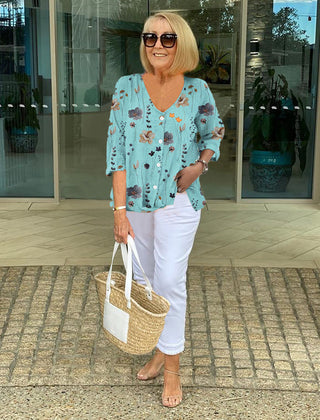 Printed button tunic top in sky blue with floral pattern, three-quarter sleeves