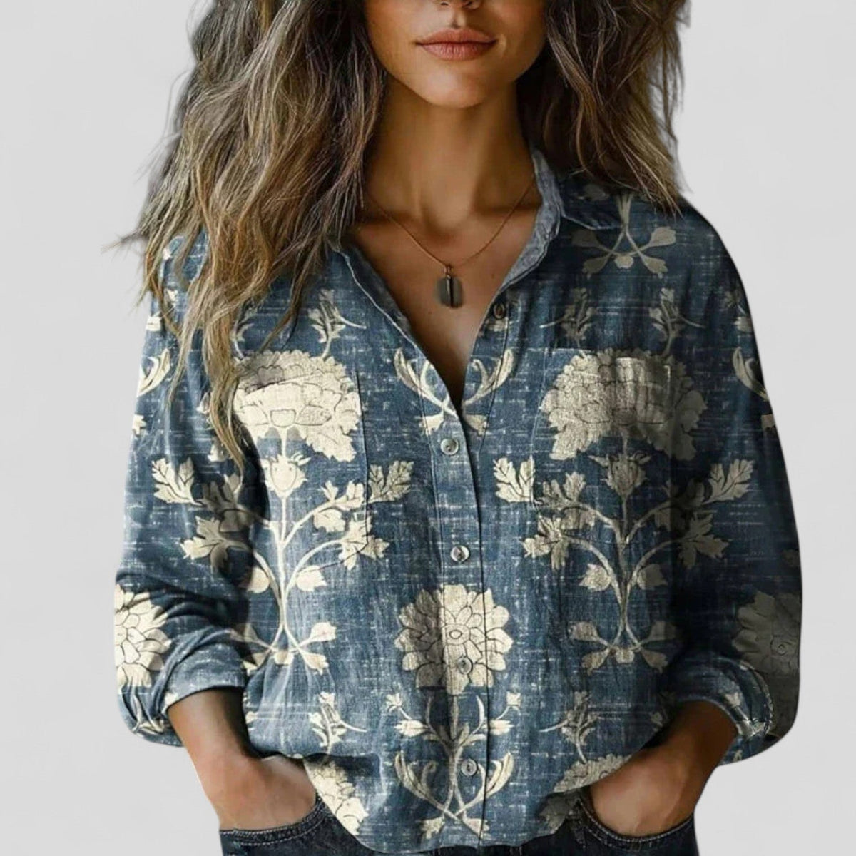 Blue botanical print button-up blouse shirt with rolled sleeves and front buttons