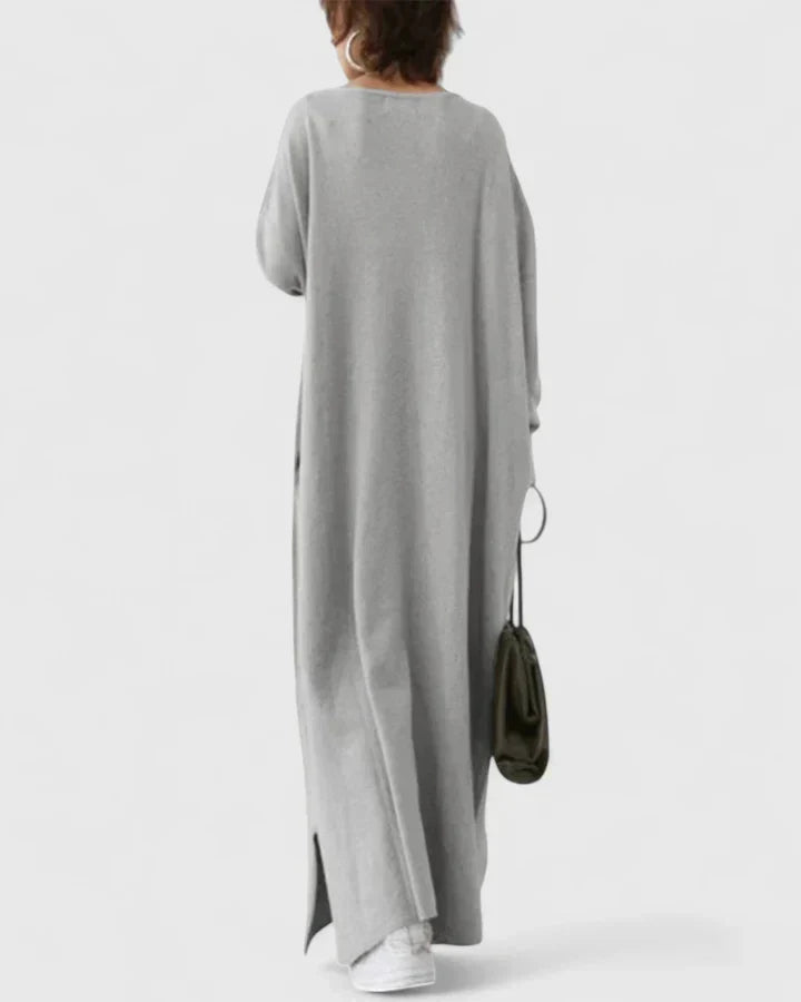 Back view of gray long-sleeve maxi dress with V-neck, relaxed fit, side slit
