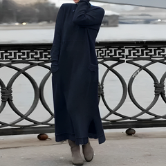 Navy hooded winter maxi dress with long sleeves, front pockets, and side slit