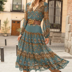 Teal midi dress with gold pattern, V-neck, long sleeves, tiered skirt and belt
