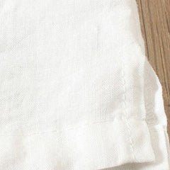 White woven fabric hem with visible texture and stitched edge