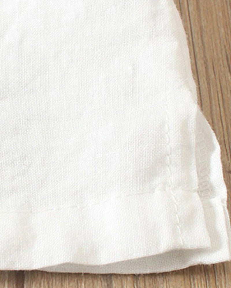 White woven fabric hem with visible texture and stitched edge