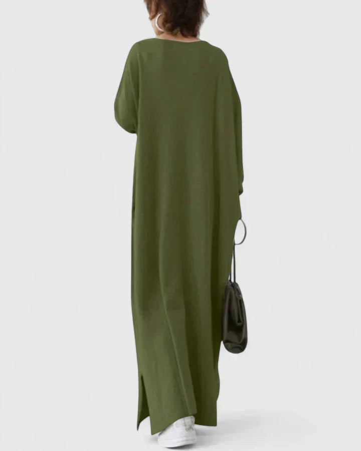 Back view of dark green long-sleeve maxi dress with V-neck and side slit hem