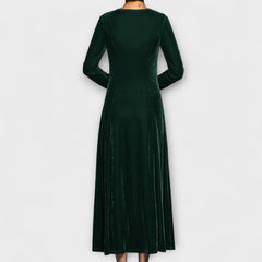 Green velvet dress back view with long sleeves and midi length flowy skirt