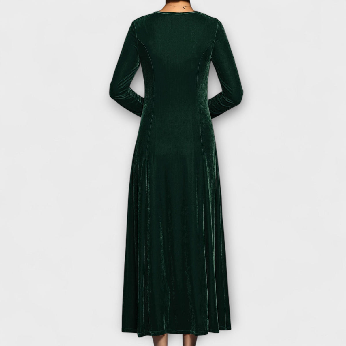 Green velvet dress back view with long sleeves and midi length flowy skirt