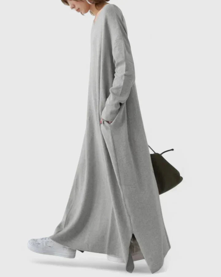 Gray long-sleeve maxi dress with V-neck and side slit, flowing ankle-length hem