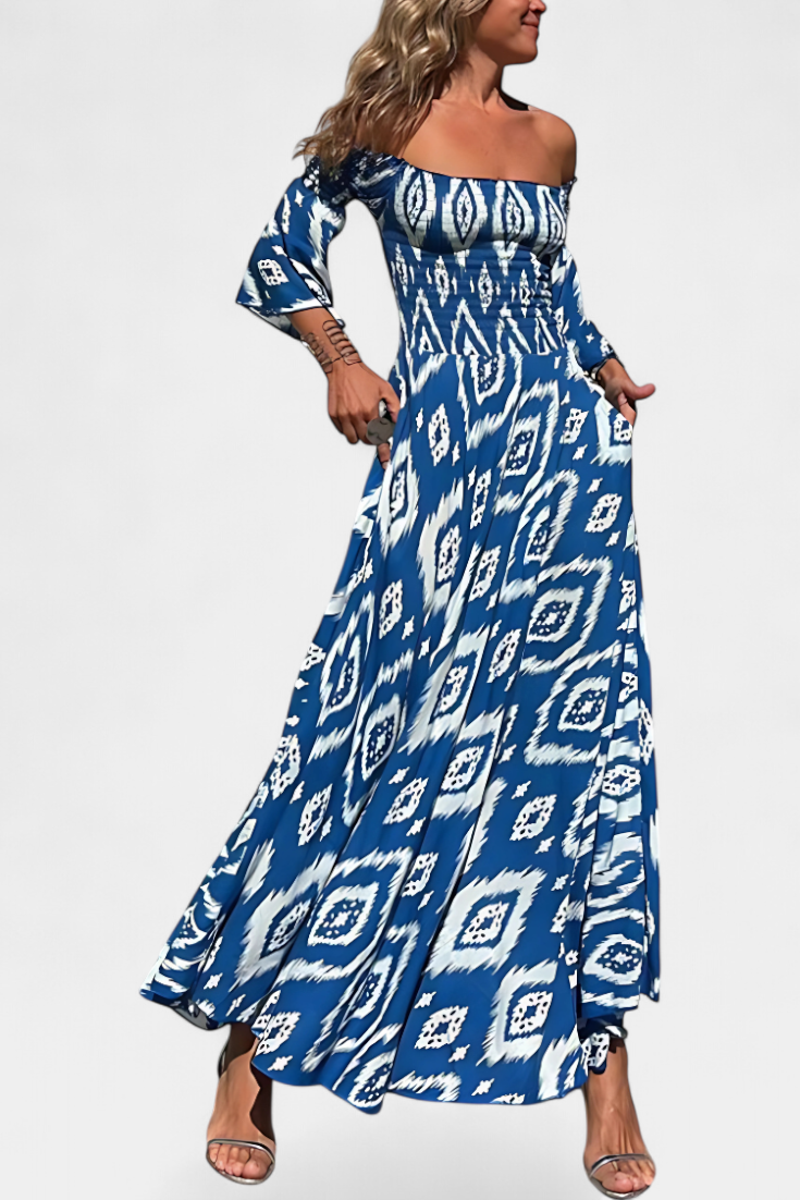 Blue off-shoulder maxi dress with long flared sleeves and bold geometric pattern