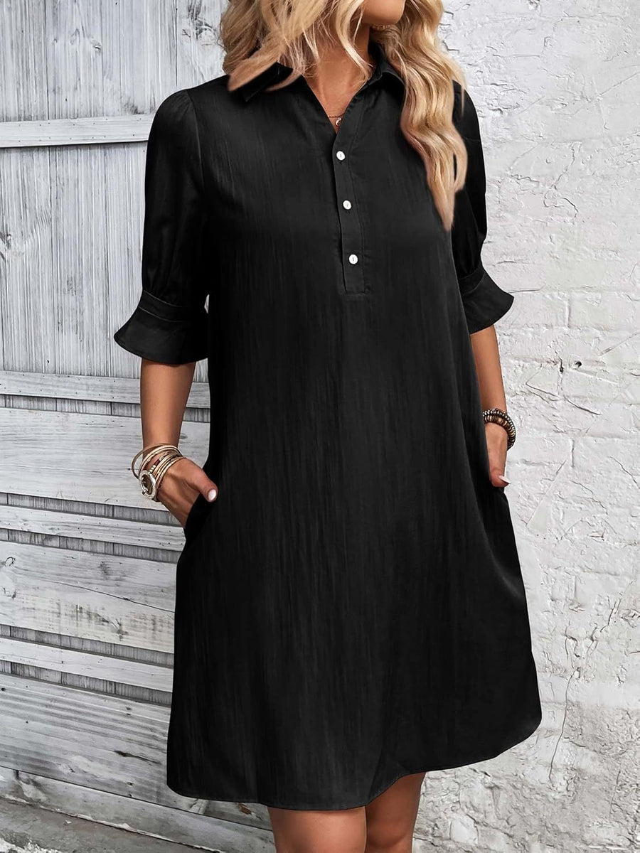 Black button-up shirt dress with pointed collar and ruffled sleeve cuffs