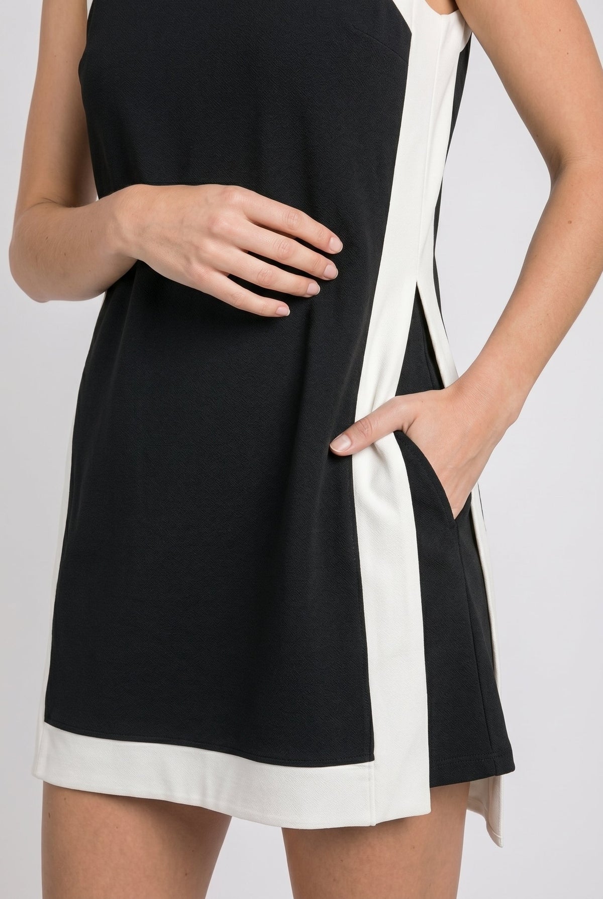 Black sleeveless dress with white hem band and side stripe detail